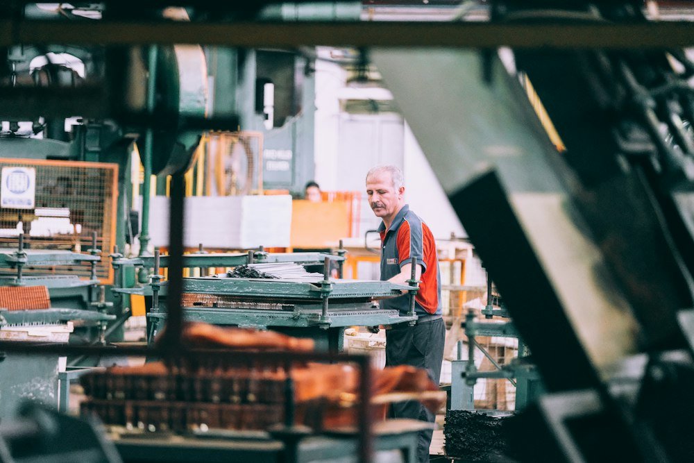 Operator working industrial machinery on a factory floor